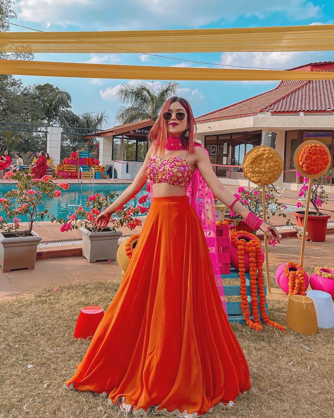 Riya Jain also knows as caughtinacuff looking ethereal in orange and pink lehenga.